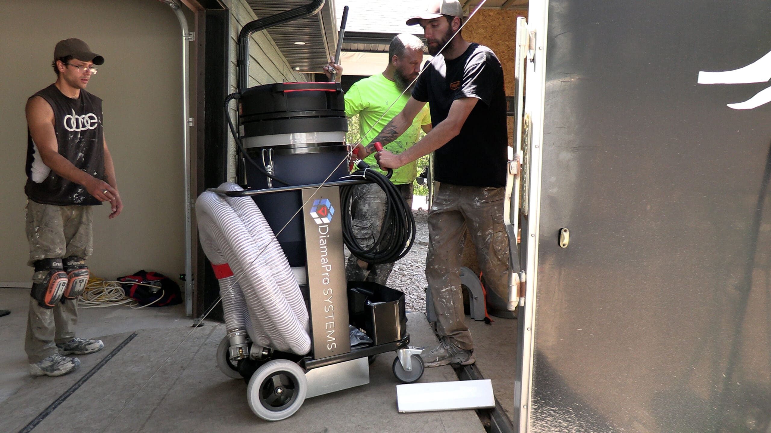 Black Mountain Epoxy Floors crew unloading grinding equipment at a job site in Spearfish, SD.