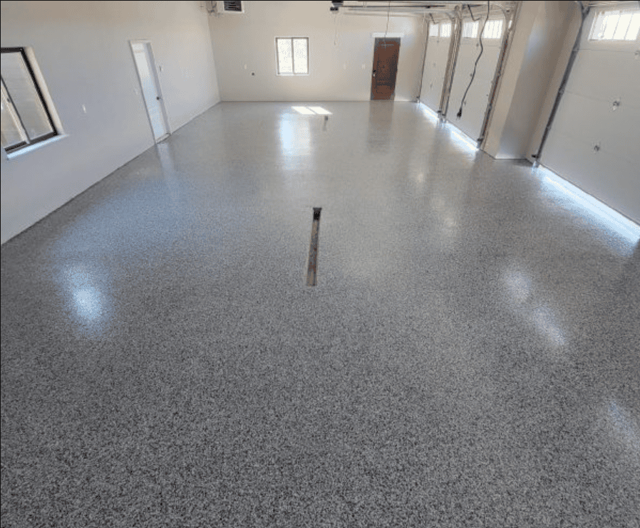 Gray flake epoxy floor coating in a multi-car garage, installed by Black Mountain Epoxy Floors in Spearfish, SD.