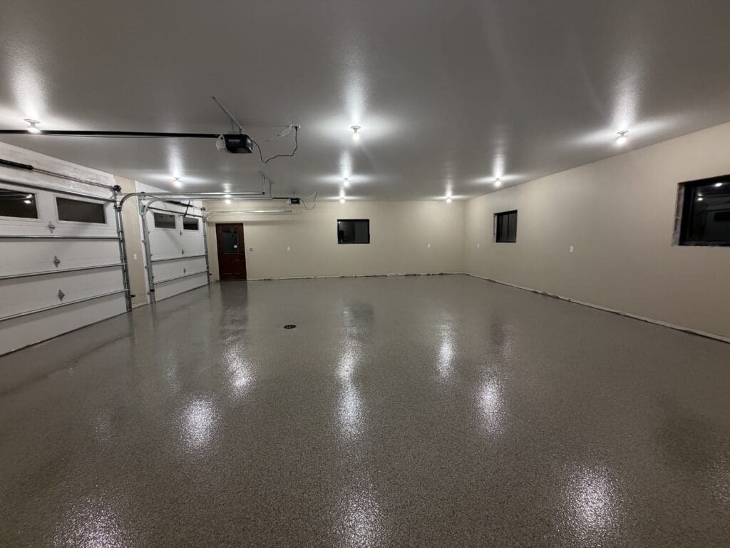 Gray flake epoxy floor coating in a large multi-car garage, installed by Black Mountain Epoxy Floors in Spearfish, SD.