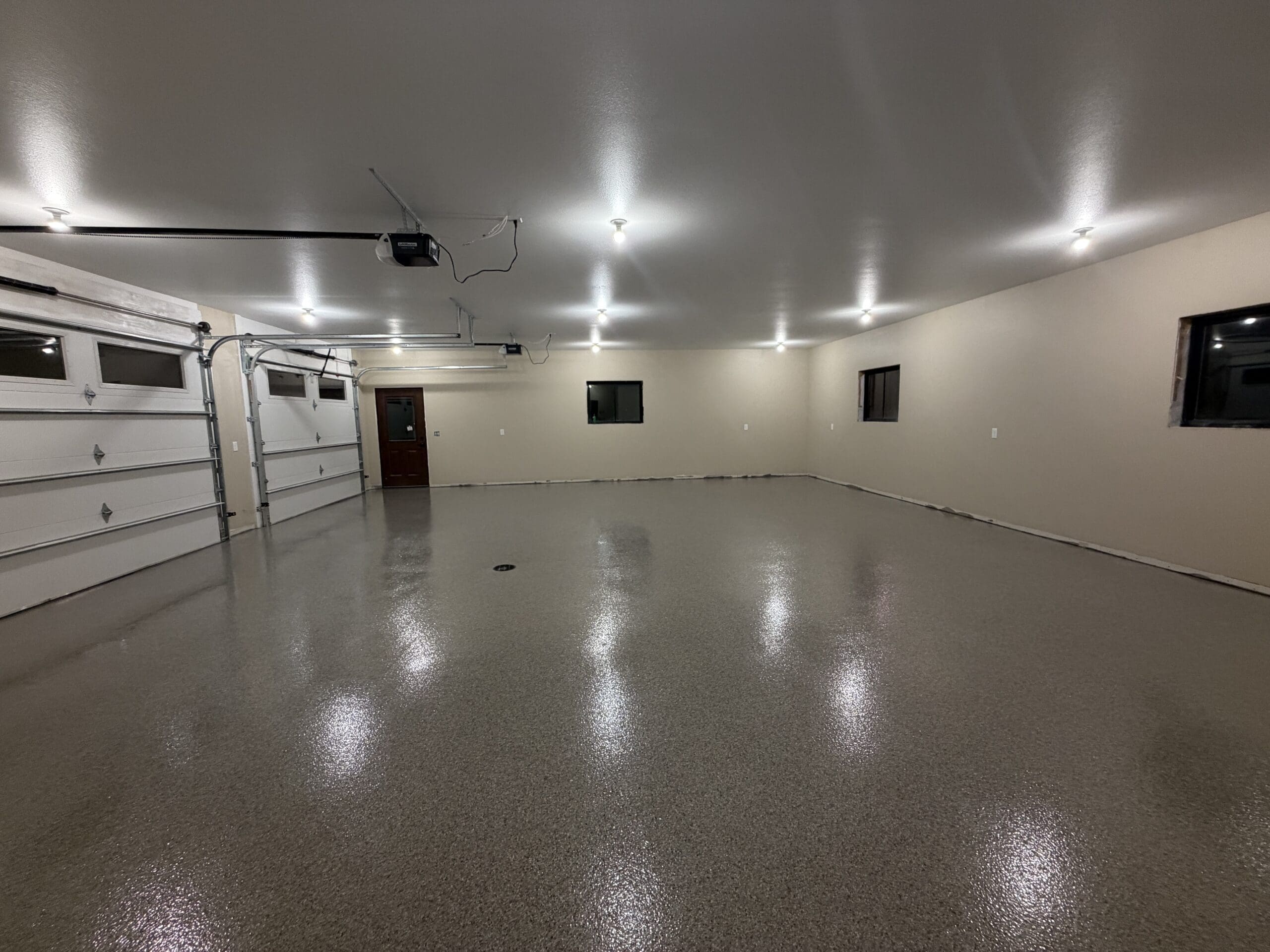 Gray flake epoxy floor coating in a large multi-car garage, installed by Black Mountain Epoxy Floors in Spearfish, SD.
