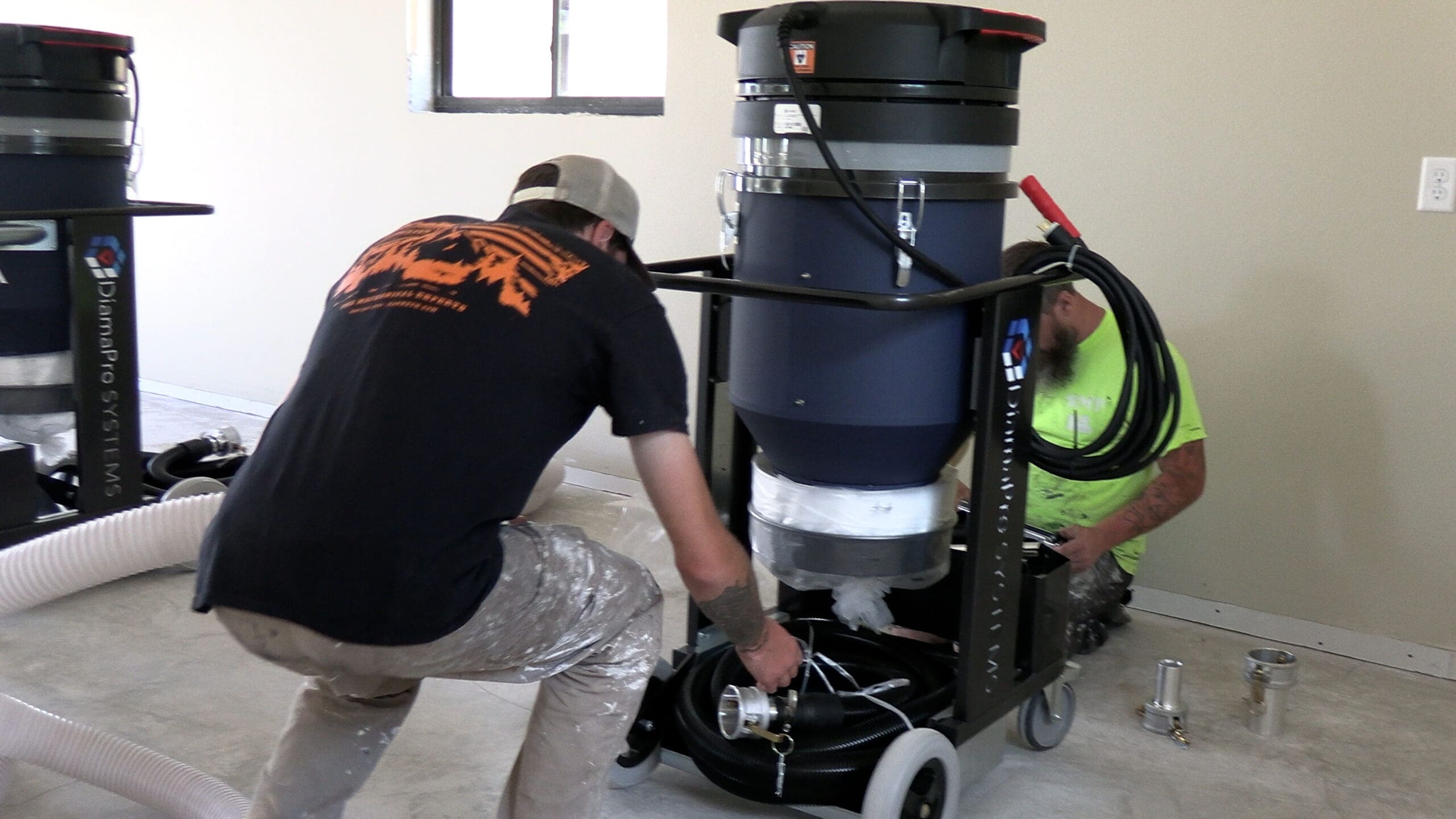 Black Mountain Epoxy Floors crew assembling a concrete grinder before an epoxy floor install in Spearfish, SD.
